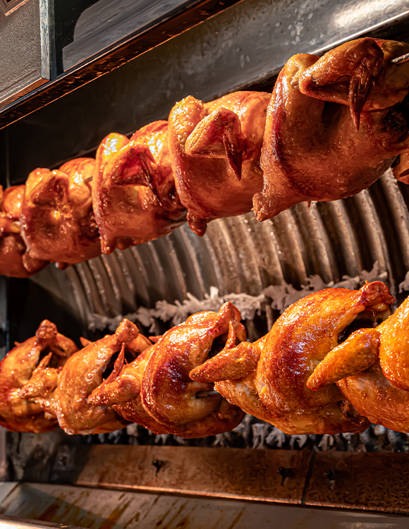 Golden rotisserie chicken at Can Bestia